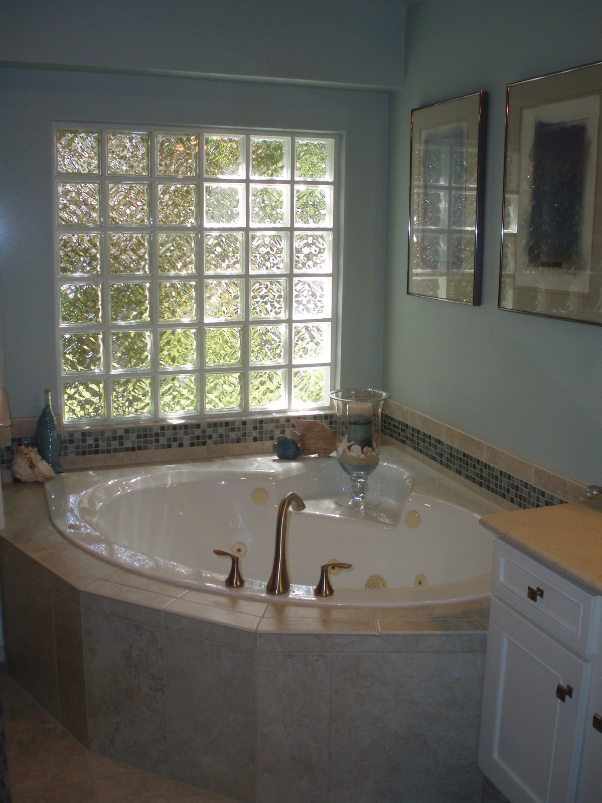The same master bathroom with a mosaic tile band, repainted walls and updated fittings